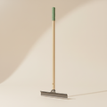 Manual lawn edger on a warm off-white studio background